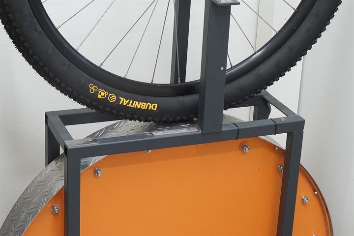Continental Dubnital Race Grip road bike tire on a rolling resistance test machine