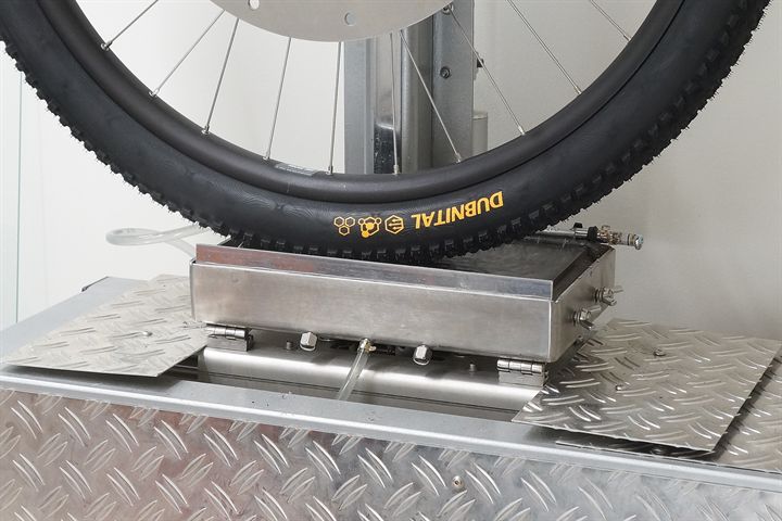 Continental Dubnital Race Grip road bike tire on a grip test machine