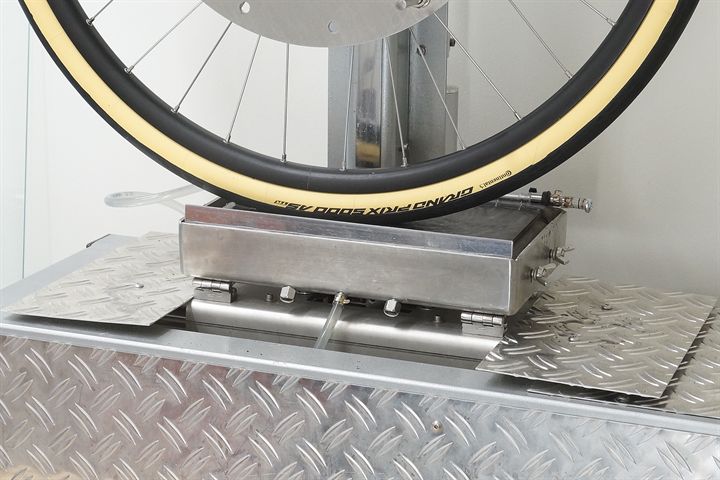 Continental Grand Prix 5000 All Season TR (cream) road bike tire on a grip test machine